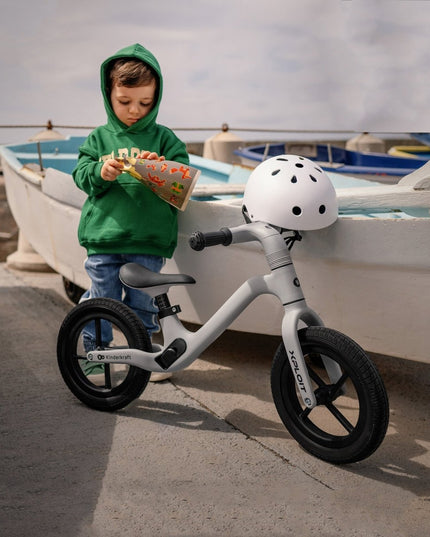 A toddler with the Kinderkraft XPLOIT Balance Bike