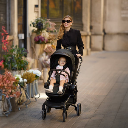 Fashionable Mima Creo Stroller Black near a floral shop with a parent.