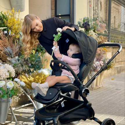 Child and mother at a flower shop with the Mima Creo Stroller Black.