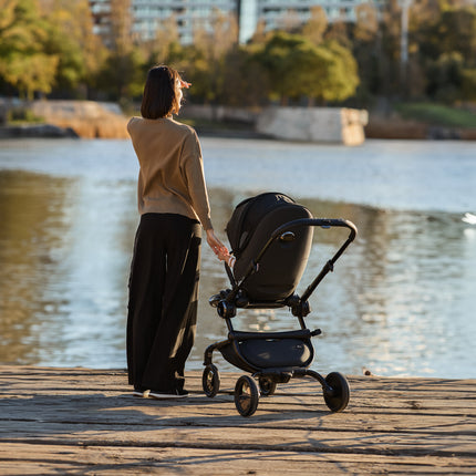 Child in the Mima Creo Stroller Black looking at the lake