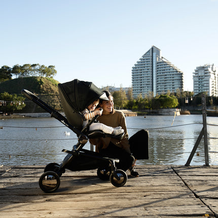 Mima Creo Stroller Black near the lake with a mother and child.