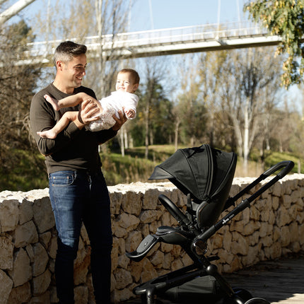 Father and child enjoying the park with the Mima Creo Stroller Black.