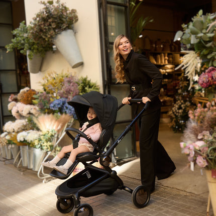 Mima Creo Stroller Black offering a smooth ride for a child in an urban setting