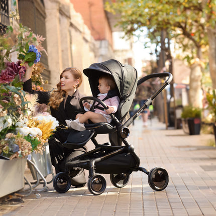 Admiring flowers in the city with the Mima Creo Stroller Black and a child.