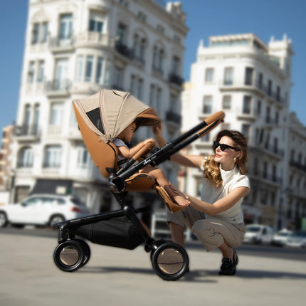 Woman looking at Mima Creo Stroller Mocha with child inside.