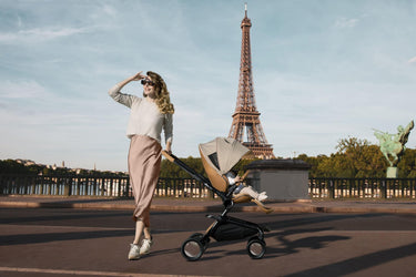 Woman with Mima Creo Stroller Mocha walking near Eiffel Tower