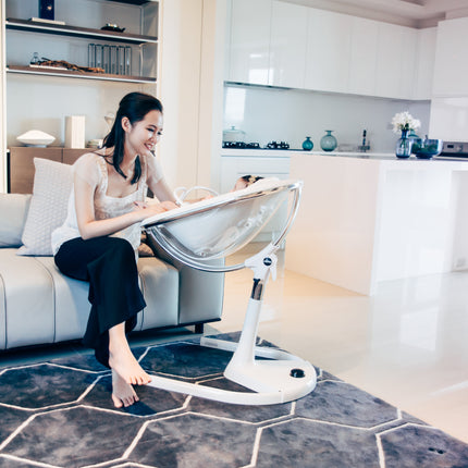 Boy sitting comfortably in Mima Moon High Chair