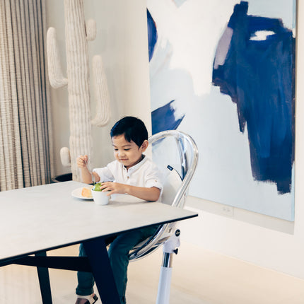 Boy eating in Mima Moon High Chair