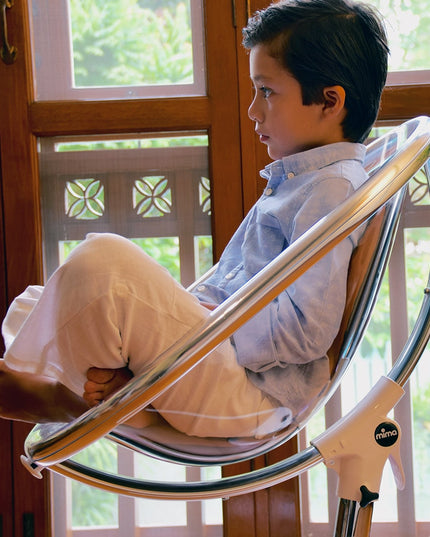 Boy sitting in Mima Moon High Chair