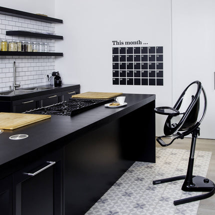 Modern kitchen with a Mima Moon High Chair beside the counter.