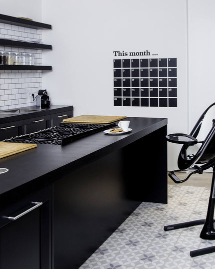 Modern kitchen with a Mima Moon High Chair beside the counter.