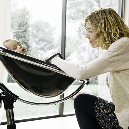 Mother smiling at her baby in a Mima Moon High Chair.