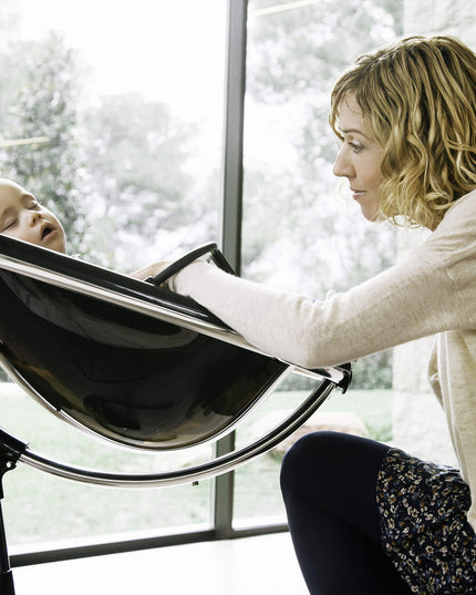 Mother smiling at her baby in a Mima Moon High Chair.