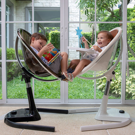 wo children playing in Mima Moon High Chairs by a window