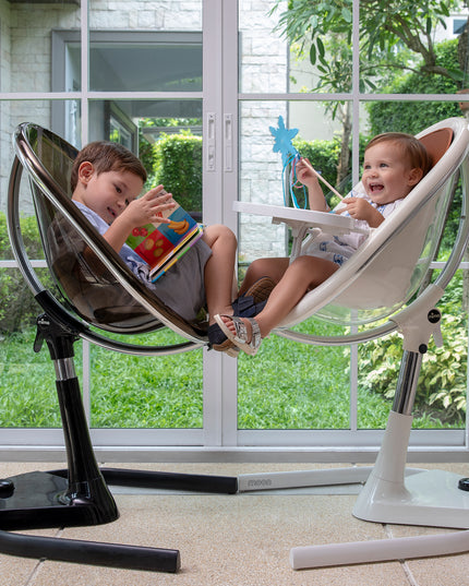 wo children playing in Mima Moon High Chairs by a window