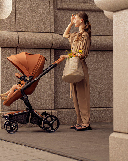 Woman with baby in Mima XARI MAX stroller in an urban area