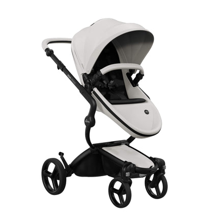 Mima XARI MAX stroller with champagne chassis, snow white seat, and black pad, facing mother.