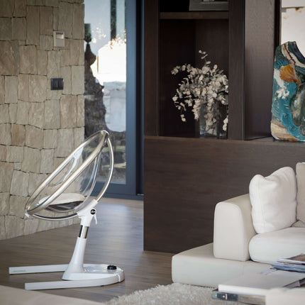 Side view of a Mima Moon High Chair in a stylish living room with elegant decor.