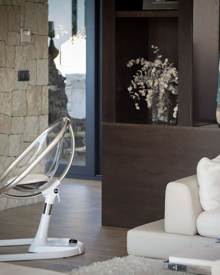 Side view of a Mima Moon High Chair in a stylish living room with elegant decor.