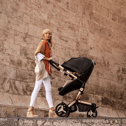 Stylish mother pushing Mima XARI MAX stroller by historical architecture