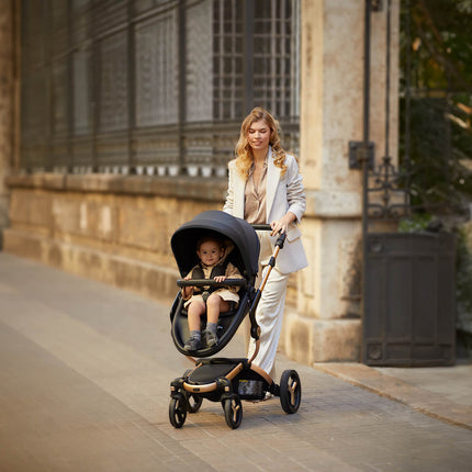 Stylish woman walking with a Mima XARI MAX stroller in an urban setting