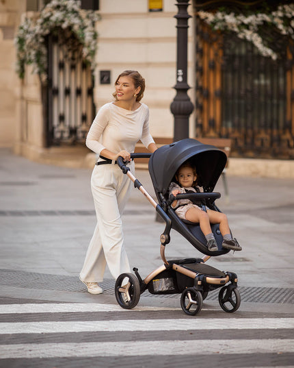 Woman crossing street with Mima XARI MAX stroller and child