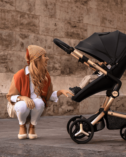 Woman with Mima XARI MAX stroller crouching to interact with child