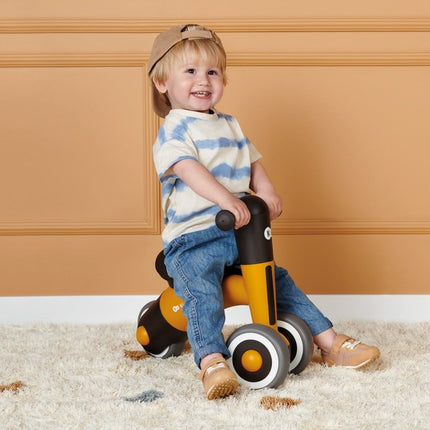 A toddler riding his Kinderkraft Balance Bike MINIBI